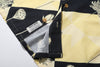 close up of corozo button closure on a Hong Kong made GOC Studio black and yellow lotus Tencel linen shirt