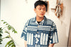 model front close up shot of GOC Studio hand indigo dyed discharge city flower cotton shirt