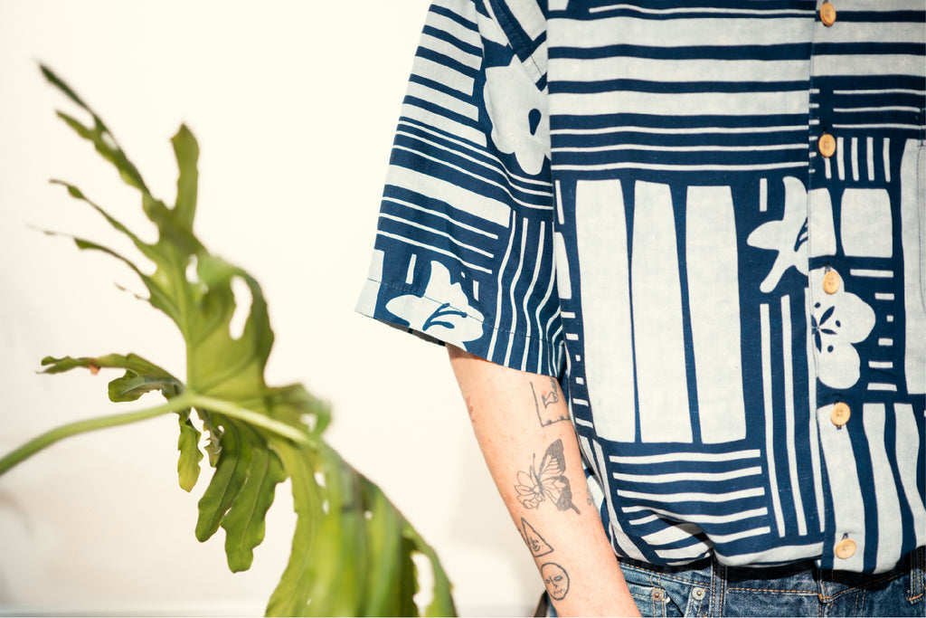 model close up shot of GOC Studio hand indigo dyed discharge city flower cotton shirt