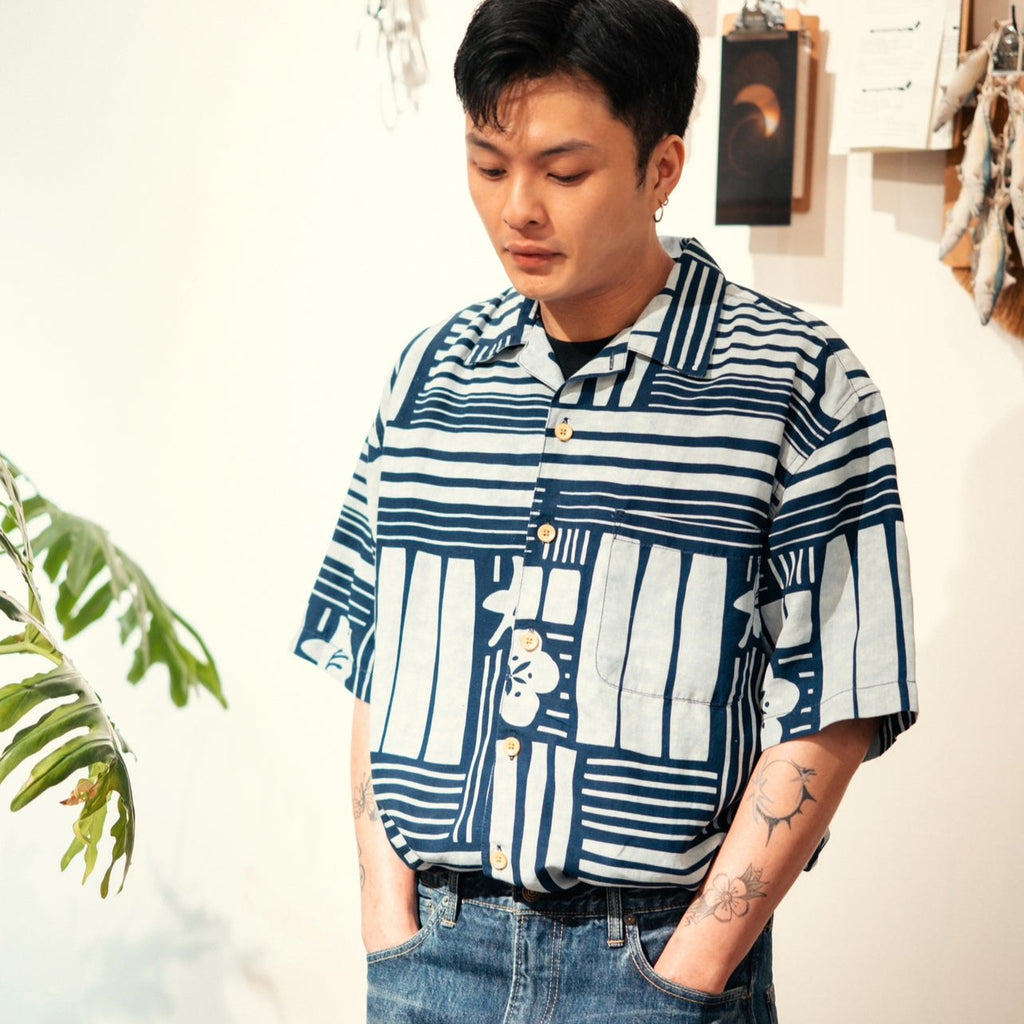 model front mid-shot of GOC Studio hand indigo dyed discharge city flower cotton shirt