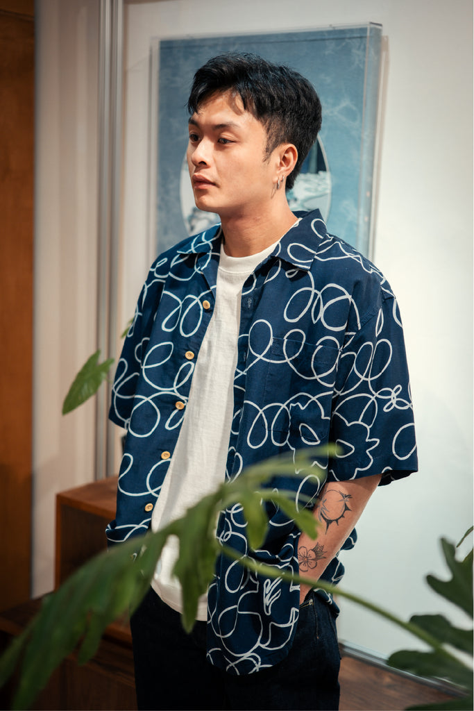 model mid-shot of GOC Studio hand indigo dyed discharge field flower cotton shirt