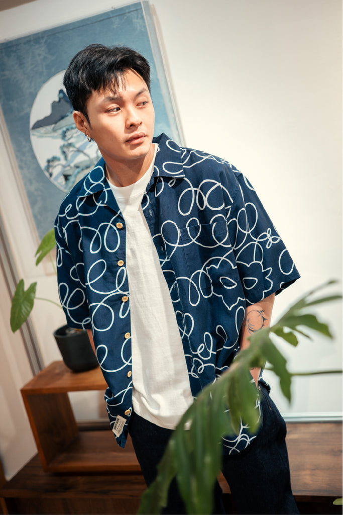 model mid-shot of GOC Studio hand indigo dyed discharge field flower cotton shirt