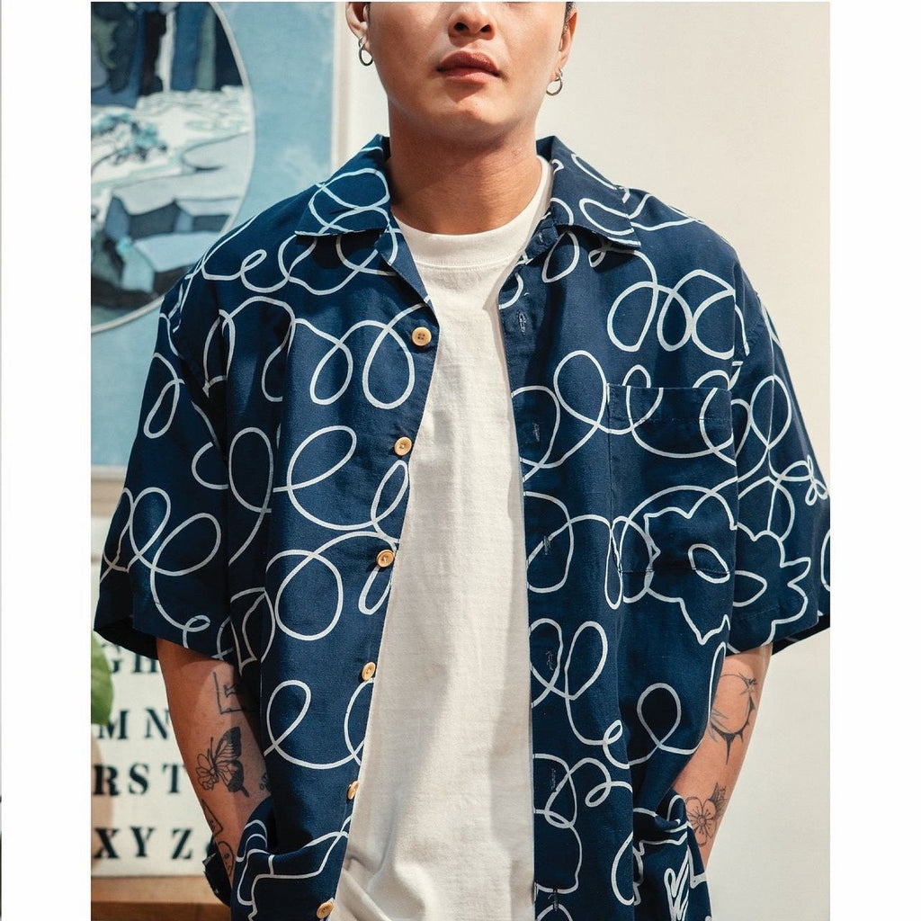 model front close up shot of GOC Studio hand indigo dyed discharge field flower cotton shirt