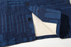 close up of corozo button closure and front placket on goc studio indigo dyed discharge floral print cotton vest 