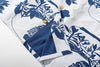 close up of corozo button closure on goc studio indigo dyed discharge teapot floral print cotton shirt