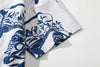 close up of sleeve hem and stitching detail on goc studio indigo dyed discharge teapot floral print cotton shirt