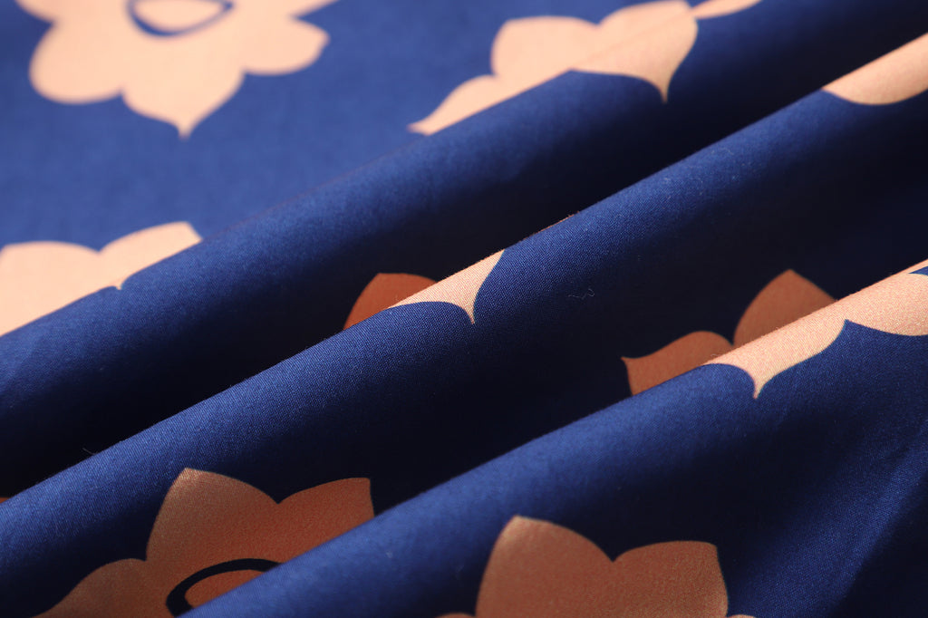 close up of navy and orange daffodil cotton poplin fabric texture