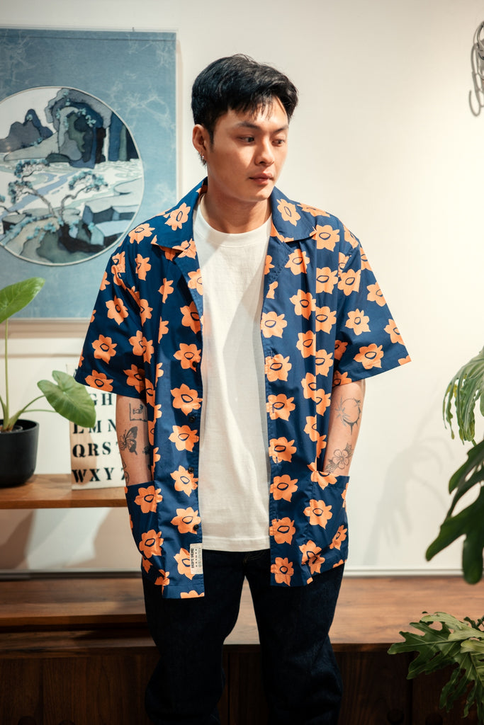 model front mid-shot of a Hong Kong made GOC Studio navy and orange daffodil cotton poplin shirt