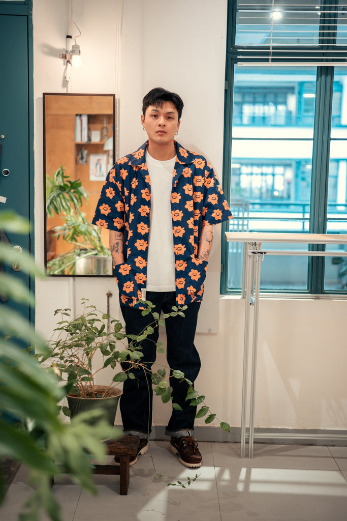 model full shot of a Hong Kong made GOC Studio navy and orange daffodil cotton poplin shirt