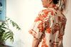 model back close up shot of a Hong Kong made GOC Studio orange teapot Tencel linen shirt