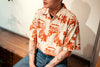 model front close up shot of a Hong Kong made GOC Studio orange teapot Tencel linen shirt
