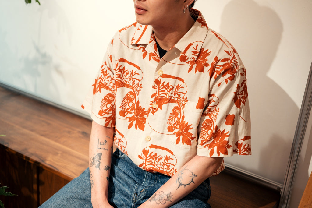 model front close up shot of a Hong Kong made GOC Studio orange teapot Tencel linen shirt