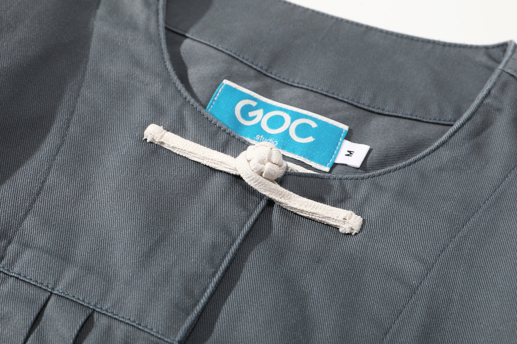 close up of first contrast colored traditional knot button on a Hong Kong made GOC Studio steel blue Japanese cotton twill oriental jacket