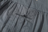 close up of front pleat detail and tonal traditional knot button on a Hong Kong made GOC Studio steel blue Japanese cotton twill oriental jacket
