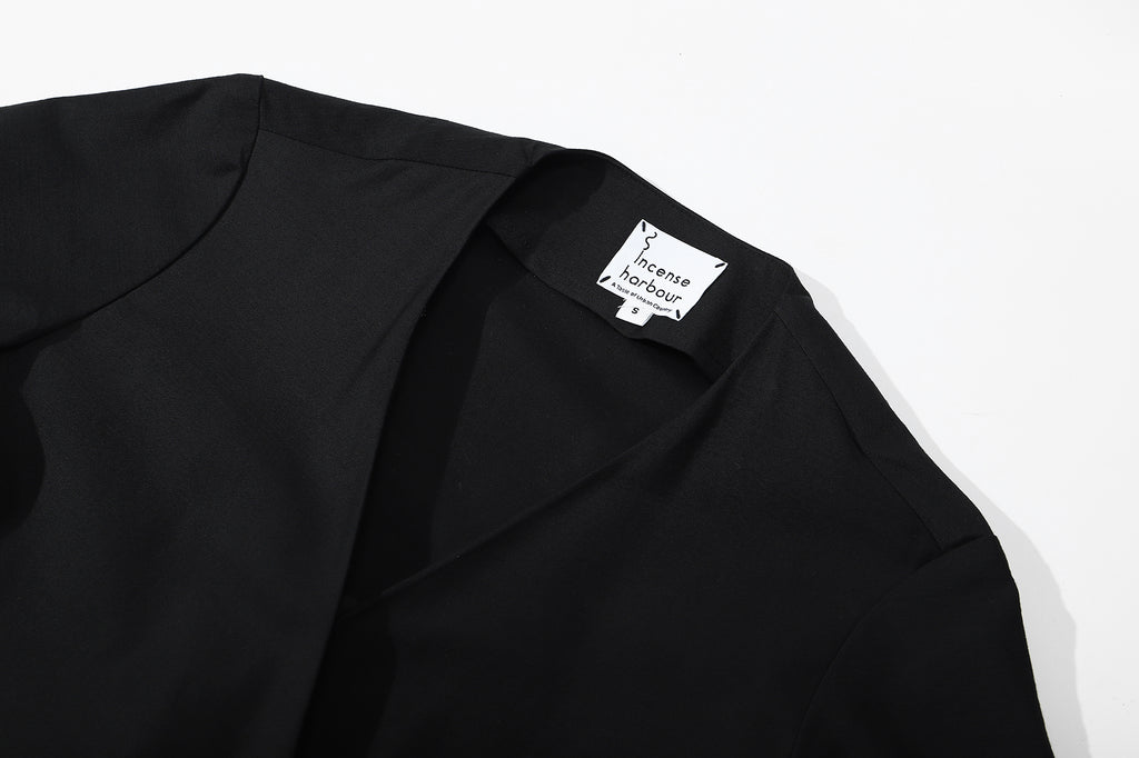 ih black cotton sateen dress close up of the elegant wrap style V neckline construction