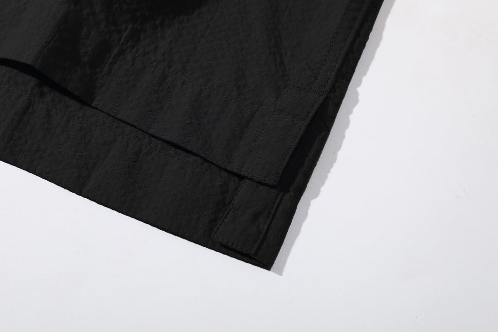 close up of side vents at hem on incense harbour black seersucker shirt