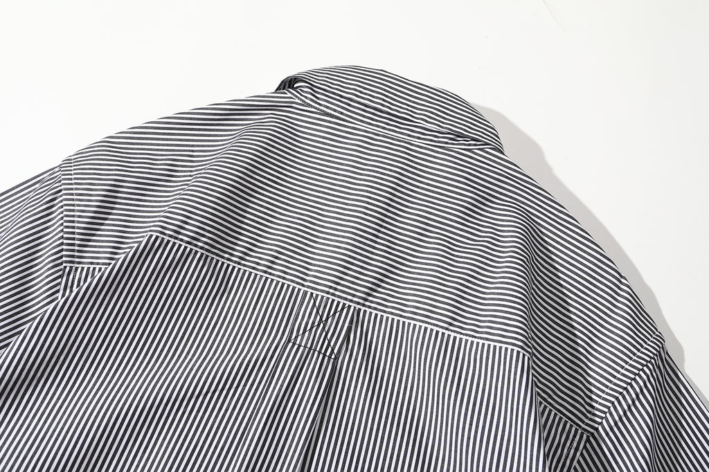 close up of box pleat detail at centre back of black stripe cotton shirt