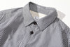 close up of mitered stripe contrast detail on collar of black summer shirt