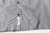 close up of front hem and clean single needle stitching on black stripe summer shirt