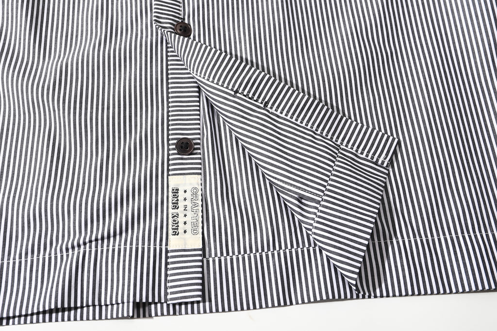 close up of front hem and clean single needle stitching on black stripe summer shirt
