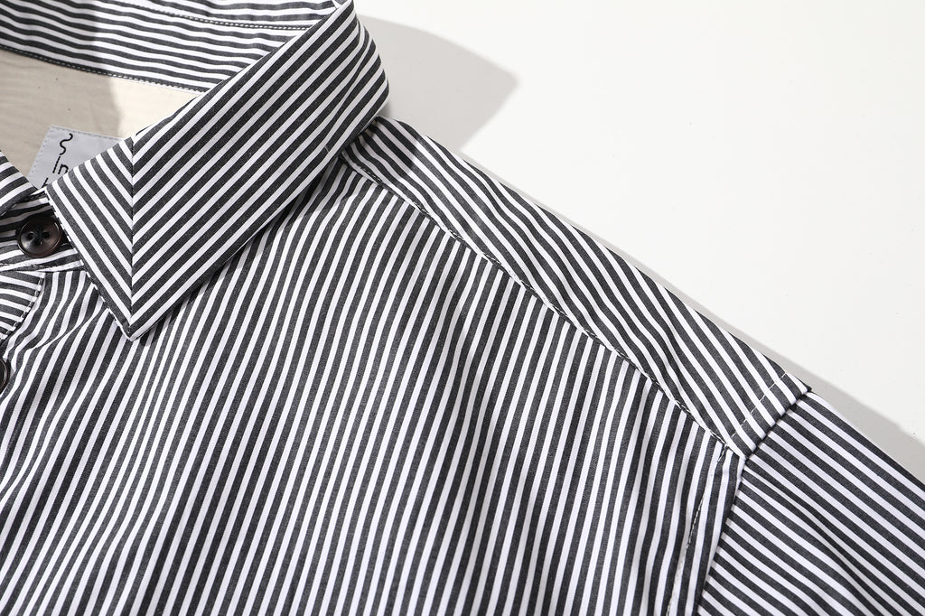 close up of mitered stripe contrast placket and corozo button closure on cotton shirt