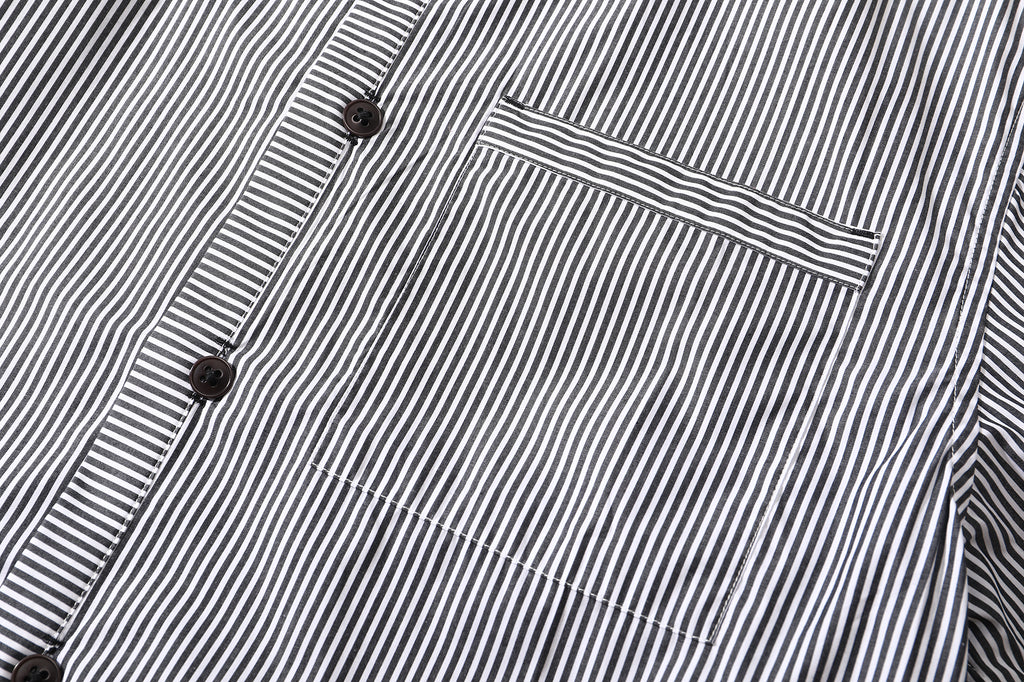 close up of mitered stripe contrast chest pocket on black vertical stripe shirt