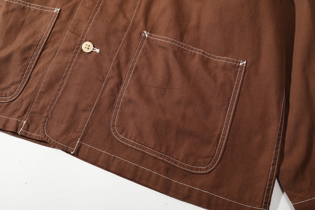 close up of front lower patch pockets showing prominent contrast stitching on edges