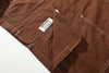 close up of jacket lower hem design with contrast stitching and crafted label detail