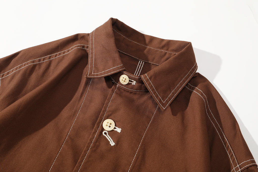 close up of vintage style chin strap and collar with contrast stitching on brown jacket