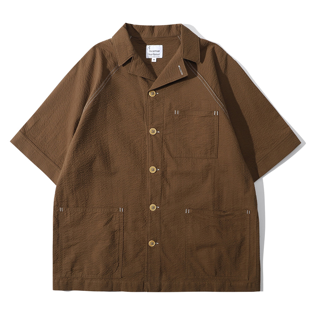 Front view of a Hong Kong made ih relaxed fit seersucker raglan chore summer shirt in brown
