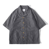 Front view of a Hong Kong made ih relaxed fit summer raglan chore shirt in chambray blue