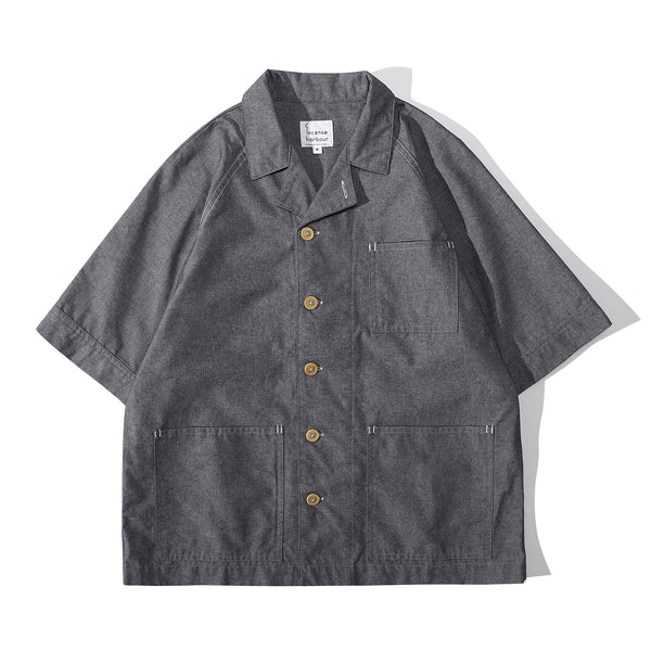 Front view of a Hong Kong made ih relaxed fit summer raglan chore shirt in chambray blue