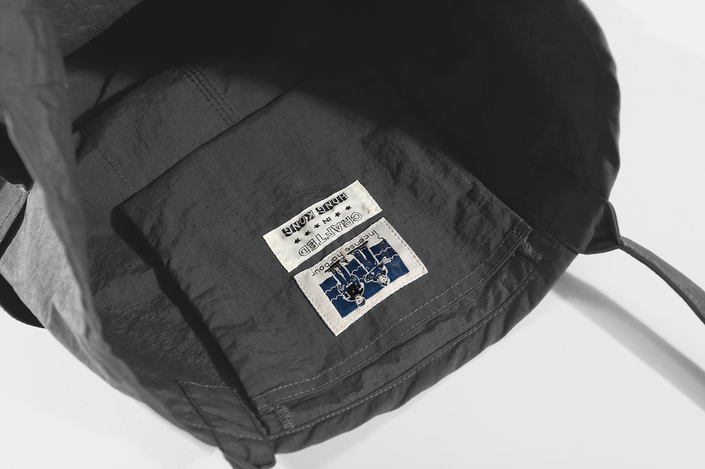 close up of front multi slot tool compartments on charcoal waterproof nylon tote