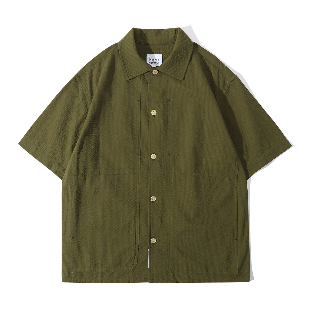 Front view of a Hong Kong made ih relaxed fit and boxy cut seersucker summer shirt in hunter green