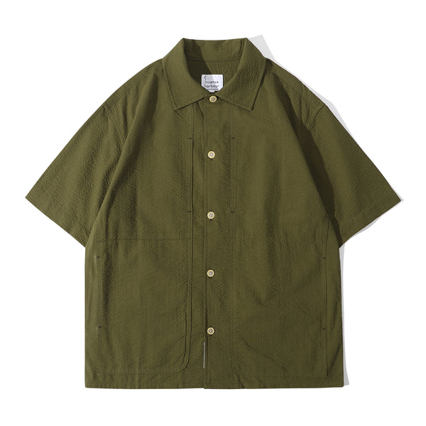 Front view of a Hong Kong made ih relaxed fit and boxy cut seersucker summer shirt in hunter green