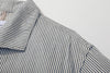 close up of unique swallow collar and neckline design on navy stripe jacket