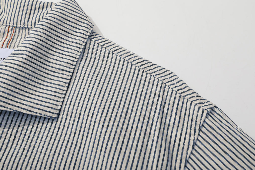 close up of unique swallow collar and neckline design on navy stripe jacket
