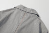 close up of contrast colour stitching detail along the center back seam of stripe jacket
