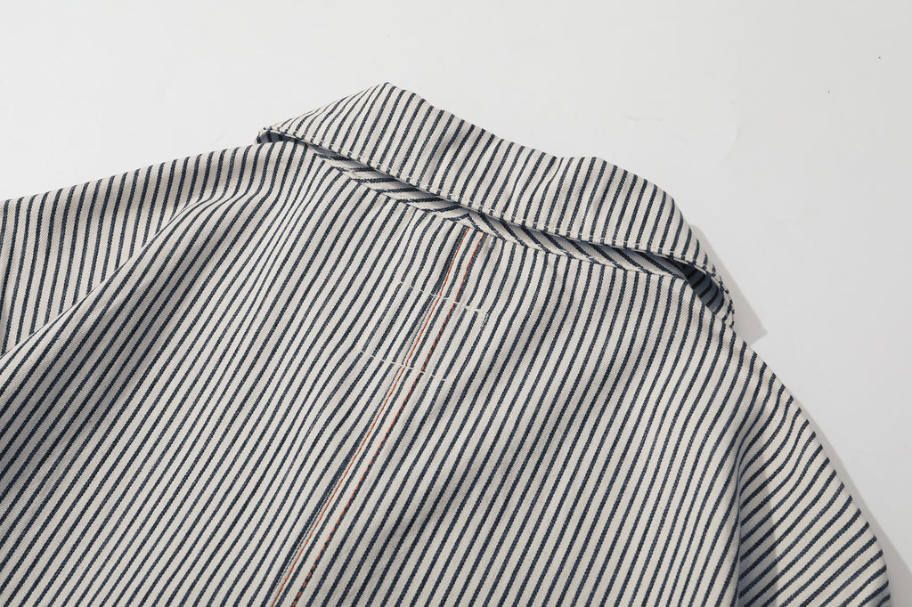 close up of contrast colour stitching detail along the center back seam of stripe jacket