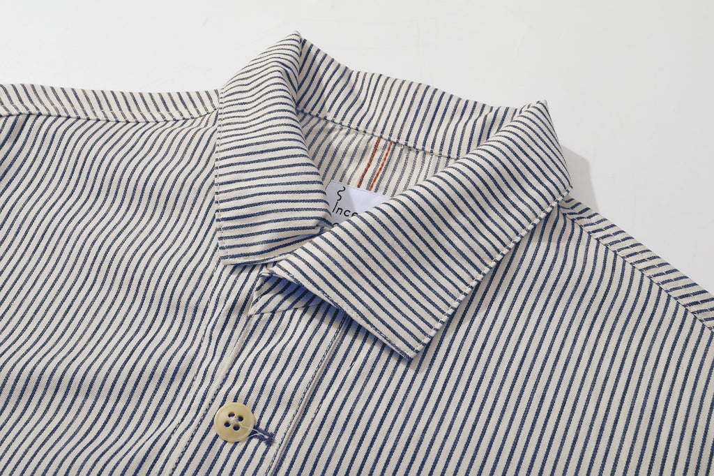 close up of front closure and premium corozo buttons on stripe casual jacket