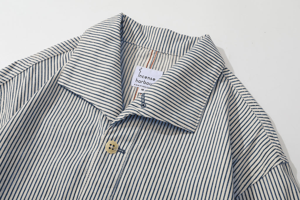 close up of unique swallow collar and neckline design on navy stripe jacket
