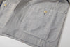 close up of unique cross side seams patch pockets detail on navy stripe jacket