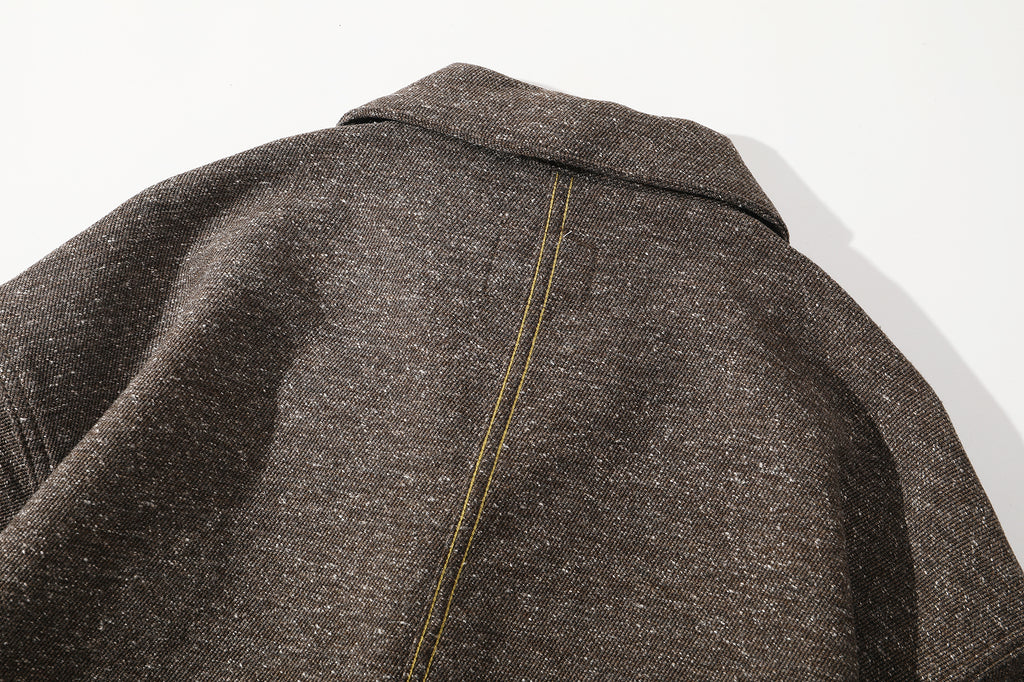 close up of contrast color stitching along the center back seam on premium japanese fabric featuring white nepps