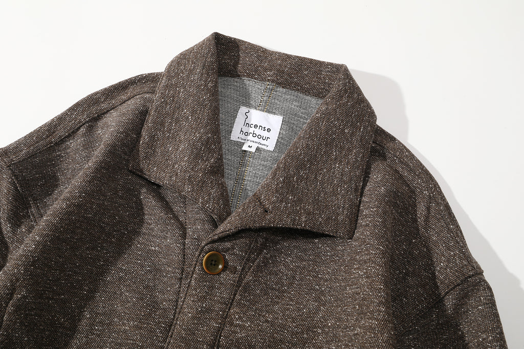 close up of unique swallow collar and neck design on nepped stone brown jacket