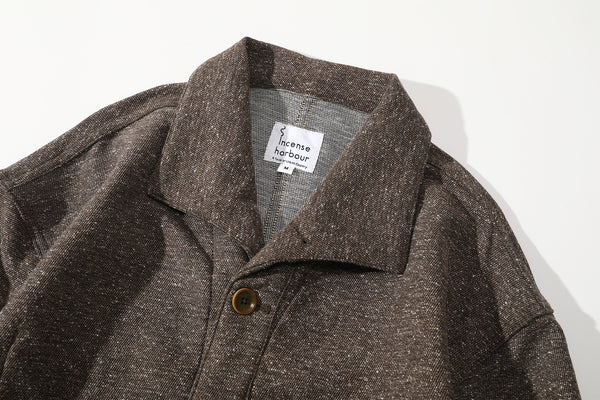 close up of unique swallow collar and neck design on nepped stone brown jacket
