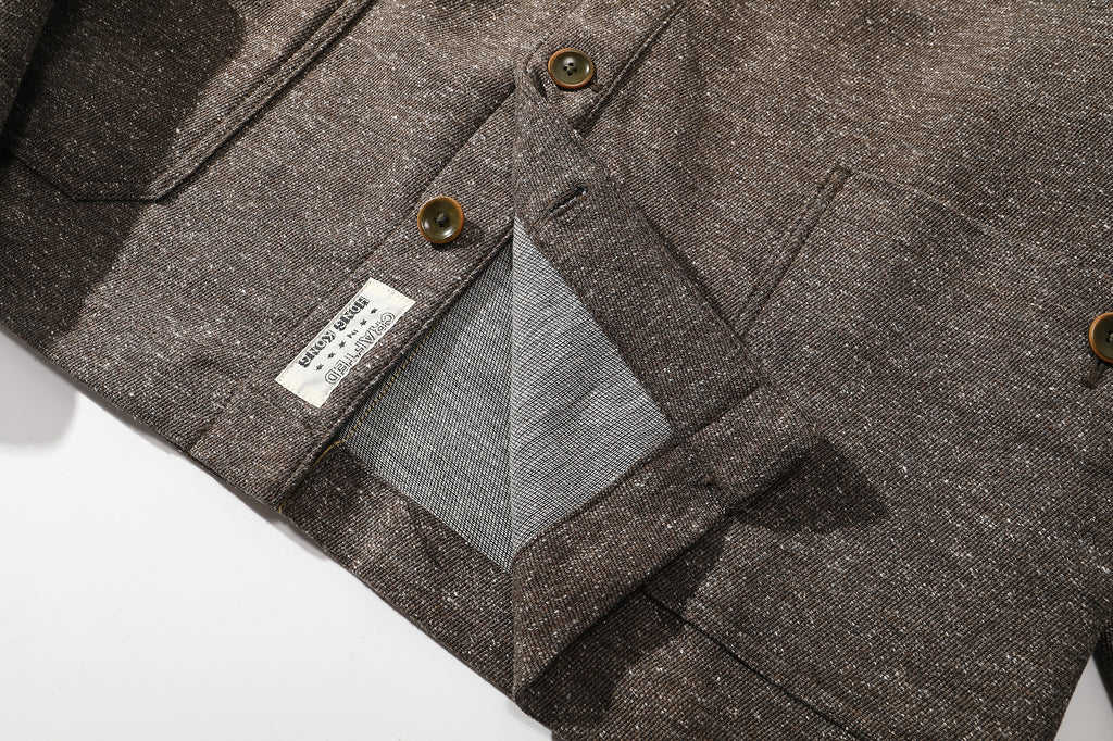 close up of jacket lower hem design and original craft label