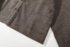 close up of the distinctive cross side seams patch pockets detail on stone brown jacket
