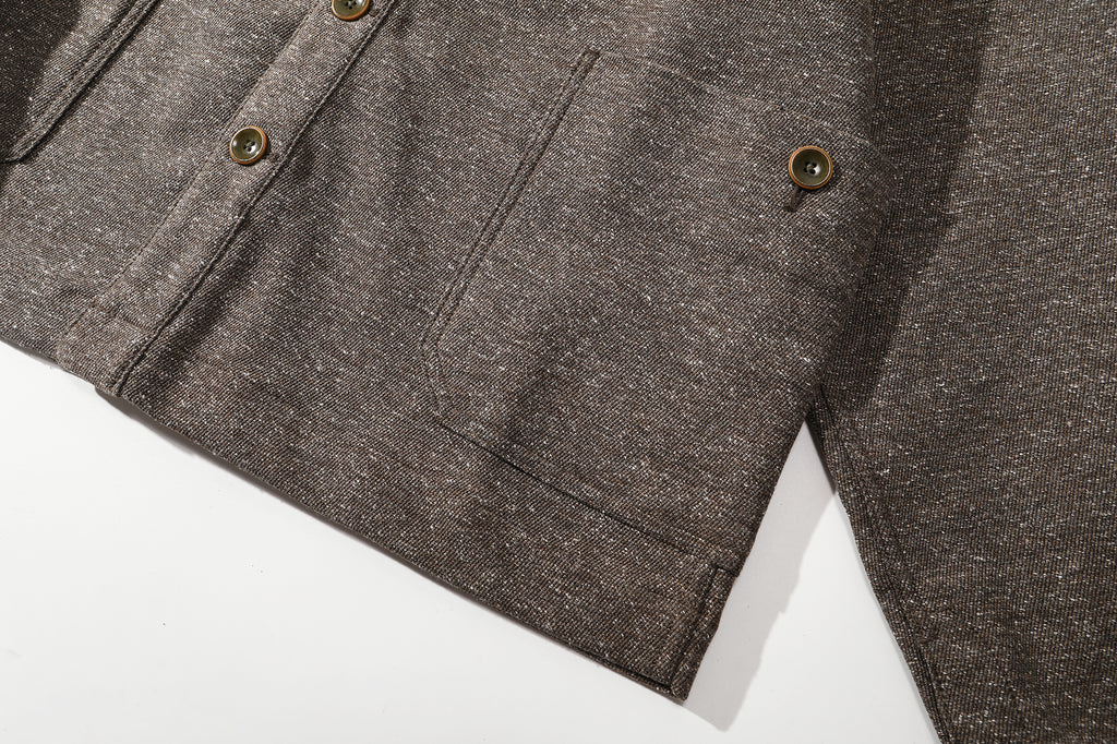 close up of the distinctive cross side seams patch pockets detail on stone brown jacket