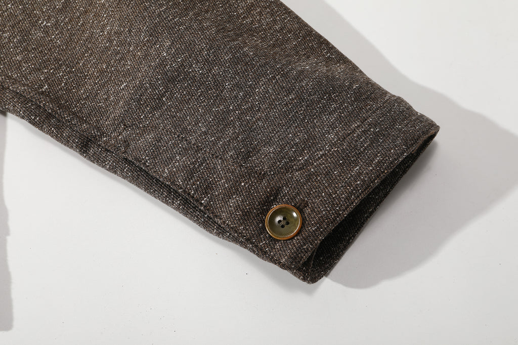 close up of sleeve cuff and functional button closure detail on nepped stone brown jacket