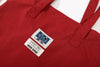 close up of ih brand woven label on the premium red daily 2 way tote